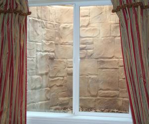 Basement Egress Window Wrapped in Stone