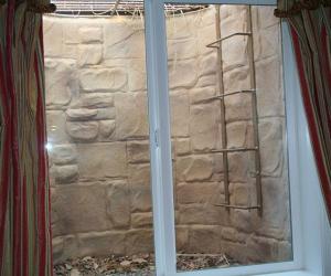 Basement Egress Window Wrapped in Stone