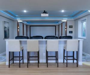 custom home theater with bar and lounge seating, 2021