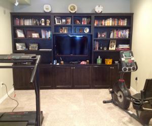 Workout equipment near tv bookcase